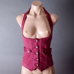 Material (Faux Suede): 92% Polyester 8% Spandex Elasticized Halter Neck Button-Front Closure Button-Tab Accents Corset Lace-Up Ties At Back Length Measured From Shoulder To Back Hem Measurement: Size S: Length (Shoulder To Back Hem): 19" Bust: Up To 35 Bust Size M: Length (Shoulder To Back Hem): 20" Bust: Up To 37 Bust Size L: Length (Shoulder To Back Hem): 21" Bust: Up To 39 Bust Fitted Button-up Vest With Buttons, Fitted Winter Tops For Cosplay, Fitted Denim Vest With Snap Buttons, Fitted Steampunk Vest For Fall, Fitted Red Top With Button Closure, Fitted Cotton Button-up Vest, Gothic Fitted Sleeveless Outerwear, Fitted Burgundy Tops With Button Closure, Fitted Burgundy Top With Button Closure