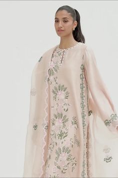 This timeless long shirt silhouette is cut from khaddi silk and is rendered with our signature floral embroidery. An organza dupatta with worked borders and rawsilk trousers complement the look. Spring Tissue Silk Kurta With Resham Embroidery, Spring Resham Embroidery Tissue Silk Kurta, Spring Floral Embroidery Raw Silk Palazzo Set, Spring Designer Tissue Silk Kurta, Designer Tissue Silk Kurta For Spring, Spring Silk Sharara With Sheer Dupatta, Silk Sharara With Sheer Dupatta For Spring, Designer Spring Kurta With Sheer Dupatta, Designer Kurta With Sheer Dupatta For Spring