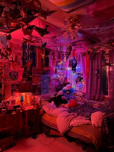 a bedroom with many decorations and lights on the ceiling is lit up in red, purple, and blue