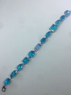 This Blue Topaz and Blue Quartz bracelet is very lively and bright. The stones are deep colors and different tones of blue The sterling silver is plated with rhodium to protect the bracelet from tarnish and give the appearance of white gold. 8 inches All jewelry is shipped in a nice gift box. Check out our over a THOUSAND great reviews Engraving is $4 per letter and is not always perfect depending on the piece. It can take a few days if the jeweler is busy. This is payable to Paypal Judithsltd@g Blue Bracelet With Gemstone Accents As Gift, Blue Bracelets With Gemstone Accents As A Gift, Blue Bracelets With Gemstone Accents For Gift, Modern Blue Multi-stone Jewelry, Elegant Blue Faceted Bracelets, Luxury Blue Bracelets With Gemstone Accents, Modern Blue Topaz Blue Jewelry, Modern Blue Jewelry With Gemstone Accents, Elegant Blue Multi-stone Bracelets