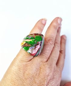 This ring is part of the Pollock line and is called Gotejado. This is the multicolor version which features a marbled motif in an array of colors. This is a size 6.75. I also have the necklaces, bracelets and earrings in this pattern. The first United Nations Conference to address environmental degradation was held in Stockholm in 1972. Already at that time the designer Carlos Sobral was working with resin and creating new techniques and alternative products to reuse all the raw material he cons Adjustable Multicolor Enamel Ring For Gift, Colorful Handmade Ring Gift, Colorful Handmade Rings For Gifts, Colorful Handmade Rings As Gift, Unique Rainbow Rings As Gift, Unique Rainbow Colored Rings As Gift, Unique Rainbow Rings For Gifts, Green Enamel Open Ring, Multicolor Jewelry With Unique Design As Gift