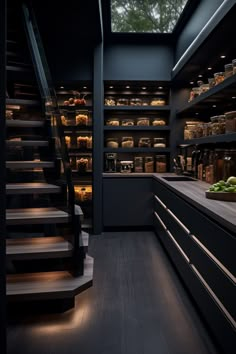 an open kitchen with lots of food on the counter and stairs leading up to it