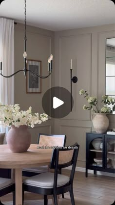 a dining room table and chairs with flowers in vases on the table next to it