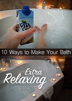 a person is taking a bath with their feet in the water and holding a bottle