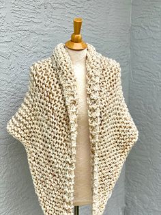 Hand knitted Outlander inspired shawl in cream blend. Wooden pin is NOT included. - triangle design, can be worn in many different ways - a small button can be attached to one of the tips, so you can secure it in the back for cross body style (if you desire a button, please include you request in a message to the seller at the check out) - super soft 90% acrylic, 10% sheep wool yarn - available in any color or yarn imaginable, please contact me for custom orders -made in smoke and pet free envir Handmade Cream Shawl For Winter, Cozy Cream Knitted Pattern, Handmade One-size Fall Wraps, Handmade One Size Acrylic Knitting Pattern, Cream Hand Knitted Shawl For Winter, Winter Cream Hand Knitted Shawl, Handmade Acrylic Yarn Shawl One Size, Cozy Cream Hand Knitted Pattern, Hand Knitted Shawl As Winter Gift