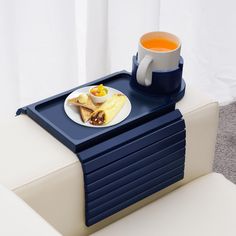 there is a tray with food on it and a cup of tea