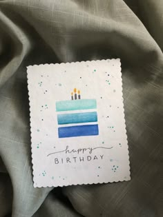 a piece of paper that says happy birthday with a cake in the middle and candles on it