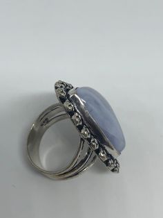 great color blue Lace agate stone The setting is handcrafted in low content silver About an inch long Size 7.5 Can be sized. My jeweler charges between $10-$15. All rings are shipped in a nice gift box. Check out our over a THOUSAND great reviews Engraving is $4 per letter and is not always perfect depending on the piece. It can take a few days if the jeweler is busy. This is payable to Paypal Judithsltd@gmail.com Adjustable Chalcedony Jewelry For Anniversary, Handmade Agate Moonstone Ring Gift, Silver Sapphire Ring With Large Stone As Gift, Blue Moonstone Healing Ring, Blue Chalcedony Round Jewelry, Blue Oval Amethyst Ring For Gift, Handmade Blue Moonstone Ring For Healing, Blue Agate Cabochon Jewelry, Blue Amethyst Gemstone Ring Gift