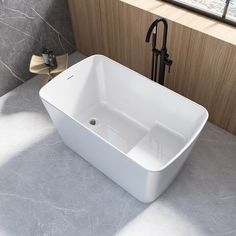 a white square sink sitting on top of a counter next to a faucet