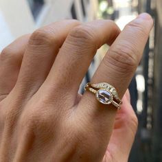 a woman's hand with a ring on it and a diamond in the middle