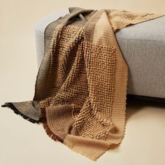 a blanket is laying on top of a couch