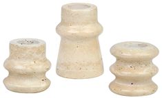 three white ceramic candlesticks on a white background