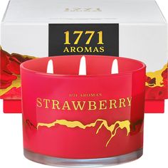 two red candles are in front of a box