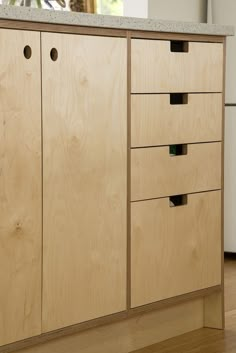 a wooden cabinet with four drawers on top of it