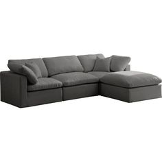 a gray sectional couch with pillows on it's back and the seat folded out