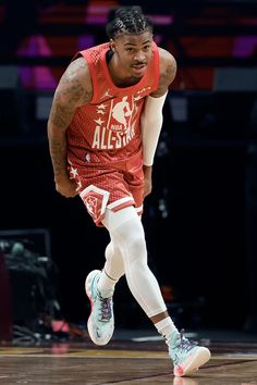 a basketball player dribbling the ball during a game