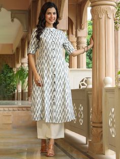 This White Ikat Print A-line Kurta from Piroh exhibits button down placket with coconut buttons details, sleeves has cuff and tab button along with Mandarin Collar & 3/4th Sleeves. Tailored from Cotton. Product Length: 45 Inches. Description Size - Measuring Unit  :  Regular Size                                 :  ( S, M, L, XL, XXL )  Shape Type                    : Straight Length Type                   :  Calf Length Color                                : White Ideal For Festive Kurta With Button Cuffs, Festive Traditional Kurta With Button Closure, Traditional Fitted Kurta With Button Cuffs, Traditional Cotton Kurta With Button Cuffs, Festive Fitted Kurta With Buttons, Fitted Festive Kurta With Buttons, Traditional White Kurta With Buttons, Elegant Fitted Kurta With Button Closure, Traditional Long Sleeve Dress With Buttons