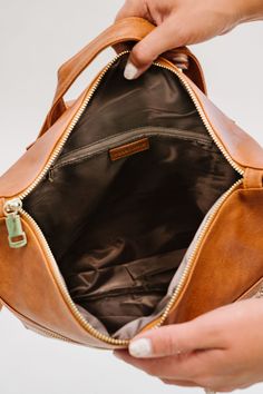 The Reese Backpack comes in two sizes (standard and oversized) to fit all you'll need to carry on the go, without looking like you're about to check your luggage. Toss in any size laptop, books, keys, wallet, and even an extra pair of shoes... without looking like you're about to go on a 12-mile hike! Each gorgeous neutral color comes in ultra-soft and durable vegan leather. The Reese features adjustable backpack straps and a top handle for a quick grab. It has two exterior pockets (one front an