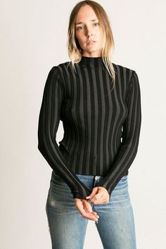 Mock neck rib knit top with long sleeves. Ella is 6' tall, 35" bust, 26" waist, 36" hip, and is wearing a size S. Trendy Fitted Turtleneck Knit Top, Black High Neck Top With Ribbed Neckline, Stretch Mock Neck Top For Fall, Fitted Knit Top With Ribbed Collar For Work, High Neck Knit Top For Fall, Knit Tops With Ribbed Neckline And Long Sleeves, Black Turtleneck Top With Ribbed Neckline, Long Sleeve Top With Ribbed Neckline, Long Sleeve Tops With Ribbed Neckline