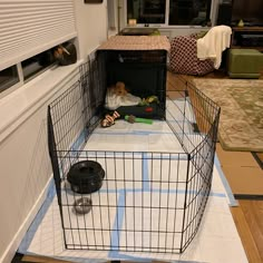 a caged in dog kennel with a stuffed animal inside it on the floor