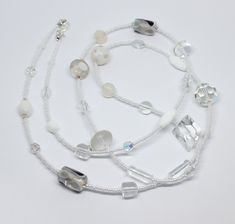 Beautiful and unique white  glass beads necklace. The necklace is made from white and clear glass and crystal beads in different shapes and sizes, making it a truly original piece. The necklace measures approximately 37.5" in length.  Please note that the beads may differ from the one pictured as each necklace is unique. Perfect gift idea or treat for yourself. Wrapped in tissue paper and presented in an organza pouch. Elegant White Crystal Necklaces With Round Beads, Elegant White Crystal Necklace With Round Beads, White Crystal Jewelry With Spacer Beads, White Crystal Beaded Chain Necklace, White Crystal Jewelry With Beaded Chain, White Single Strand Crystal Jewelry, White Beaded Long Crystal Necklace, Handmade White Crystal Necklaces, White Crystal Necklaces With Polished Beads