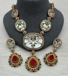 Beautiful high end choker can be paired with your favorite outfit. The blend of ruby and green make it perfect to go with any colour outfit Necklace Size - Adjustable Dori Earrings - Have Push backs Multicolor Hand Set Pendant Necklace, Elegant Multicolor Meenakari Necklace, Festive Multicolor Jeweled Bridal Necklace, Multicolor Jeweled Bridal Necklace For Festive Occasions, Elegant Multicolor Bridal Choker Necklace, Elegant Multicolor Choker Jewelry Sets, Festive Multicolor Choker Necklaces, Festive Multicolor Choker Necklace, Multicolor Choker Jewelry For Celebration