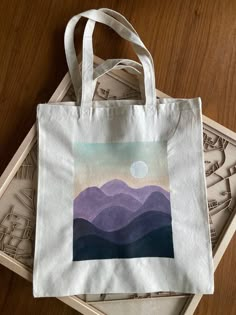 two bags sitting next to each other on top of a wooden table with money in the background