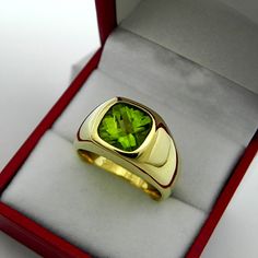 Gemstone: Peridot Treatments: Untreated Specifications: 9x9mm, approx. 3.20 carats Color: As shown Clarity: Eye clean, near flawless Cut: Cushion checkerboard cut Weight: 20 grams. Ring size: 10, with all sizes available from 6.5 through 12 This is as fine and elegant a man's ring as you will ever find. The perfect blend of a fine gemstone matched up with a clean classic 14K yellow gold ring. Good solid weight, nicely distributed to give the ring an even weight so that it will not spin. There is Formal Yellow Gold Tsavorite Rings, Luxury Peridot Ring For Formal Occasions, Luxury Peridot Jewelry For Formal Occasions, Modern Gold Jewelry With Peridot, Formal Green Gemstone Signet Ring, Green Gemstone Signet Ring For Formal Occasions, Formal Green Polished Gemstones, Formal Peridot Gemstones For May Birthstone, Modern Peridot Jewelry For Formal Occasions