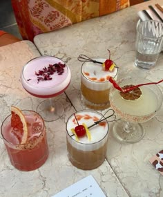 four different types of cocktails on a table