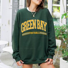 "Get ready for Green Bay football with this vintage-style, varsity sweatshirt. This crewneck has a retro design for your game day.  - These are Unisex fit. Please check sizing if you would like to order up 1-2 sizes for an oversized sweatshirt. * Packaged and Shipped in the USA! ---UNISEX SWEATSHIRTS--- - Specially spun cotton/poly, 50/50 - Medium-heavy soft fabric - Classic fit - Tear-away label - Runs true to size ---SIZES--- Small - 20\" W | 27\" L Medium - 22\" W | 28\" L Large - 24\" W | 29\" L XLarge - 26\" W | 30\" L 2XLarge - 28\" W | 31\" L 3XLarge - 30\" W | 32\" L 4XLarge - 32\" W | 33\" L ---CARE INSTRUCTIONS--- - Wash clothing inside out on cold setting - Tumble dry: low heat setting - Do not use bleach - Do not dry clean - Do not iron directly on design - Colors may look slig Oversized Tops For School Spirit In Fall, Oversized Tops For Fall With School Spirit, Fall Long Sleeve College Style T-shirt, Team Spirit Long Sleeve Sweater For College, Crew Neck T-shirt For Game Day In Fall, Collegiate Long Sleeve Sweater For Game Day, Collegiate Sweater For Game Day, Fan Apparel Long Sleeve Sweatshirt For Fall, Game Day Long Sleeve Letter Print Sweater