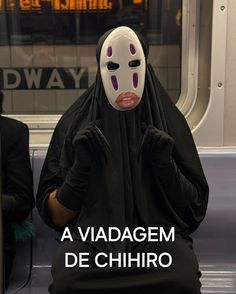 a person sitting on a train wearing a mask and covering their face with the words, a viadem de chihro