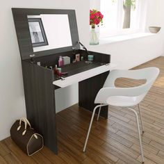 a white chair sitting next to a desk with a mirror on it