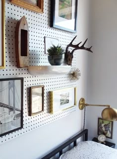 there is a wall with pictures on it and some deer antlers in the corner