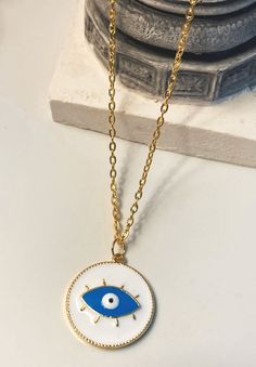 White evil eye necklace, round-shaped, stainless steel gold colour. Charm necklace for summer:) White Gold Plated Round Charm Necklace, White Round Gold Plated Charm Necklace, Trendy Gold Plated Round Necklace, Trendy Gold Circular Necklace, Trendy Gold Circle Necklace, Gold Plated Evil Eye Round Necklaces, Gold Plated Round Evil Eye Necklace, Gold Plated Evil Eye Round Necklace, White Round Pendant Necklace With Evil Eye