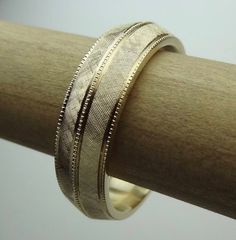 This bevel-edge  band is hand Florentine  all-round  approximately 6.5mm wide and weight is  approximately  10 to 11 grams of 14k yellow gold. The band is milgrain in the center and sides. Available in all finger sizes from 8 - 12.  Sizing outside of that range is a special order, contact for pricing and info.Each band is made to order and is a final sale.  If you need the band sooner than the listed processing time, we may able to do a rush order if our workload permits.We love this ring becaus Heirloom 14k Gold Engraved Bands, Engraved Wide Band Ring With Polished Finish For Weddings, Heirloom Gold Ring For Promise, Luxury Yellow Gold Jewelry For Marriage, Timeless Wide Band Wedding Bands, Anniversary Wedding Ring With Thick Diamond Cut Band, Yellow Gold Engraved Wedding Rings - Fine Jewelry, Round Milgrain Bands For Anniversary, Engraved 14k Gold Jewelry Thick Band