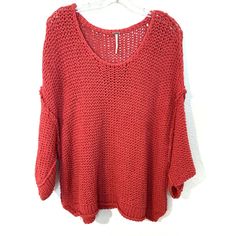 a red sweater hanging on a hanger