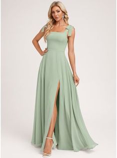 a woman in a long green dress with one leg slited and the other side split open