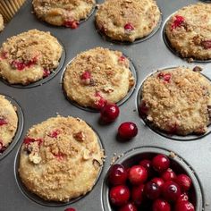 freshly baked cranberry muffins in a muffin tin with fresh cherries