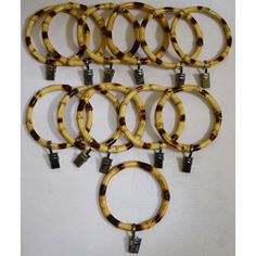 six pairs of tortoise shell bracelets with metal clasps on each end