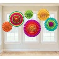 colorful paper fans hanging from the ceiling in front of a window with windowsills