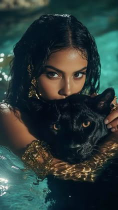 a woman is holding a black cat in the water