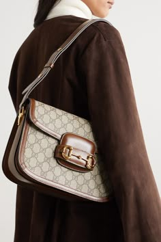 Gucci only revived its '1955' style a few seasons ago, but it's already set to be the next It bag - both Sienna Miller and Adwoa Aboah have been spotted carrying it. Made in Italy from the house's signature monogrammed coated-canvas, it has a saddle silhouette and is trimmed with tan leather. Match your jewelry to the equestrian-inspired horsebit hardware. Handcrafted Handbags, Best Designer Bags, Dream Bag, Gucci Horsebit, Dream Bags, It Bag, Sienna Miller, Bags Aesthetic, Print Coat