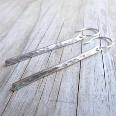 Irresistibly delicate and modern, these lightweight earrings feature 1.5 inches of hammered sterling silver. Sterling silver hook earwires. Rubber earnuts are included. . { o p t i o n s } . In Gold: https://www.etsy.com/listing/164233521/gold-stick-earrings-gold-line-earring In Rose Gold: https://www.etsy.com/listing/170001546/rose-gold-stick-earrings-hammered-earing Smooth:https://www.etsy.com/your/shops/CamileeDesigns/tools/listings/section:10244959/164234055 . { p a c k a g i n g } . Your je Minimalist Everyday Linear Earrings With Hammered Detail, Everyday Minimalist Hammered Linear Earrings, Modern Hammered Sterling Silver Linear Earrings, Modern Sterling Silver Linear Earrings With Hammered Detail, Modern Sterling Silver Hammered Linear Earrings, Modern Hammered Linear Earrings As Gift, Minimalist Hammered Long Drop Earrings, Modern Hammered Linear Earrings For Gift, Hammered Sterling Silver Linear Earrings