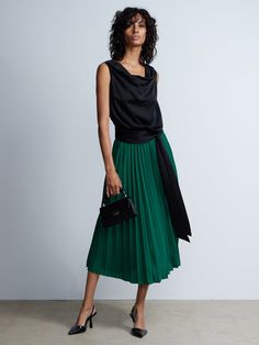 Pleated High Rise Midi Skirt | NY&Co Chic Pleated Asymmetrical Skirt For Party, Chic Asymmetrical Pleated Skirt For Party, Chic Green Flowy Pleated Skirt, Chic Long Pleated Skirt, Chic Flowy Maxi Skirt, Chic Asymmetrical Pleated Lined Skirt, Chic Asymmetrical Lined Pleated Skirt, Chic Green Pleated Skirt For Fall, Chic Green Midi Pleated Skirt