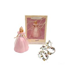 a barbie doll and jewelry are shown in front of a card that says,'the princess is coming to town '