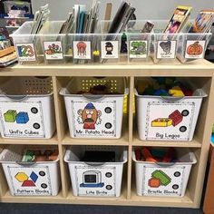 a book shelf filled with lots of books and plastic bins