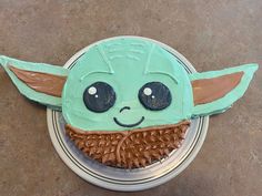 a cake shaped to look like yoda from the child's star wars movie