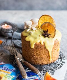 there is a cake with oranges and cinnamon on the top, surrounded by other decorations