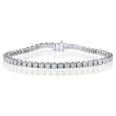 A classic tennis bracelet style showcasing a row of round brilliant diamonds, set in a polished 14k white gold mounting. 55 Diamonds weigh 3.00 carats total and are approximately GH color, SI1 clarity. Style available in different price ranges. Prices are based on your selection of the 4C’s (Carat, Color, Clarity, Cut). Please contact us for more information. Formal Diamond Tennis Bracelet Channel Set, White Gold Diamond Tennis Bracelet - Channel Set, Classic Round Cut Channel Set Diamond Bracelet, Classic Diamond Bracelet With Channel Set, Classic Channel Set Diamond Bracelet, Classic White Diamond Bracelet With Accents, Classic Channel Set Bracelet For Formal Occasions, Classic White Platinum Tennis Bracelet, Classic Diamond Tennis Bracelet With Channel Set