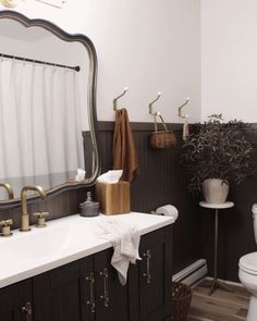 a bathroom with black cabinets and white walls